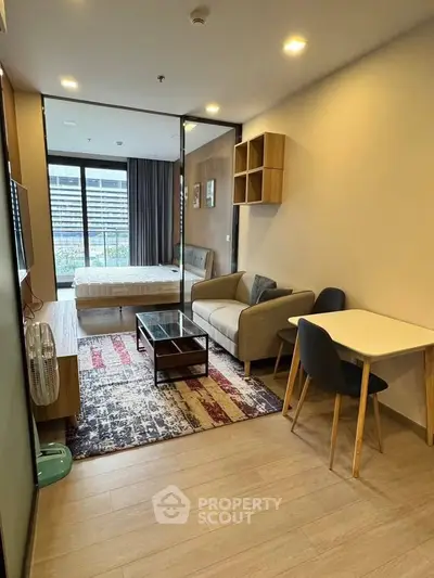 Modern living room with cozy seating and stylish decor in a contemporary apartment.