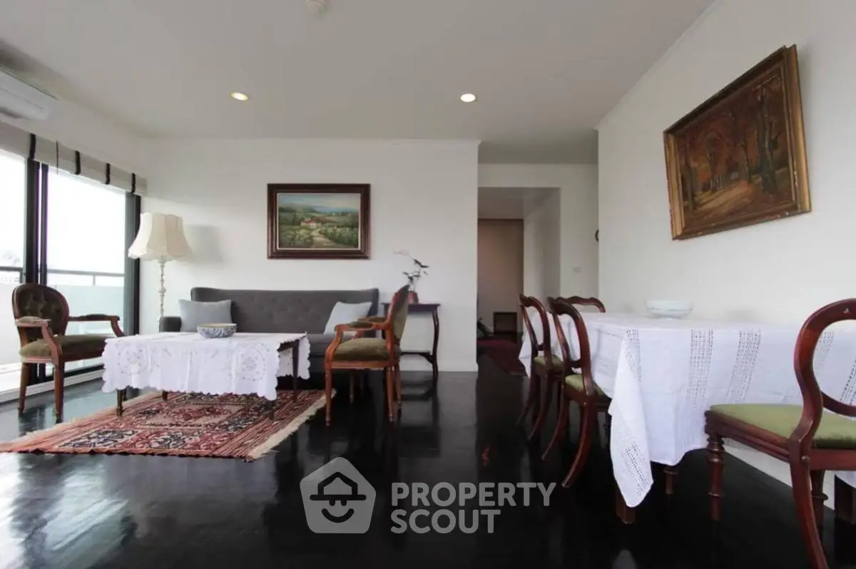 Spacious living room with elegant decor and large windows offering natural light.