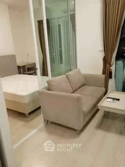 Modern apartment interior with cozy living area and bedroom, featuring stylish furniture and large windows.