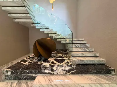 Luxurious modern staircase with marble steps and glass railing in elegant interior