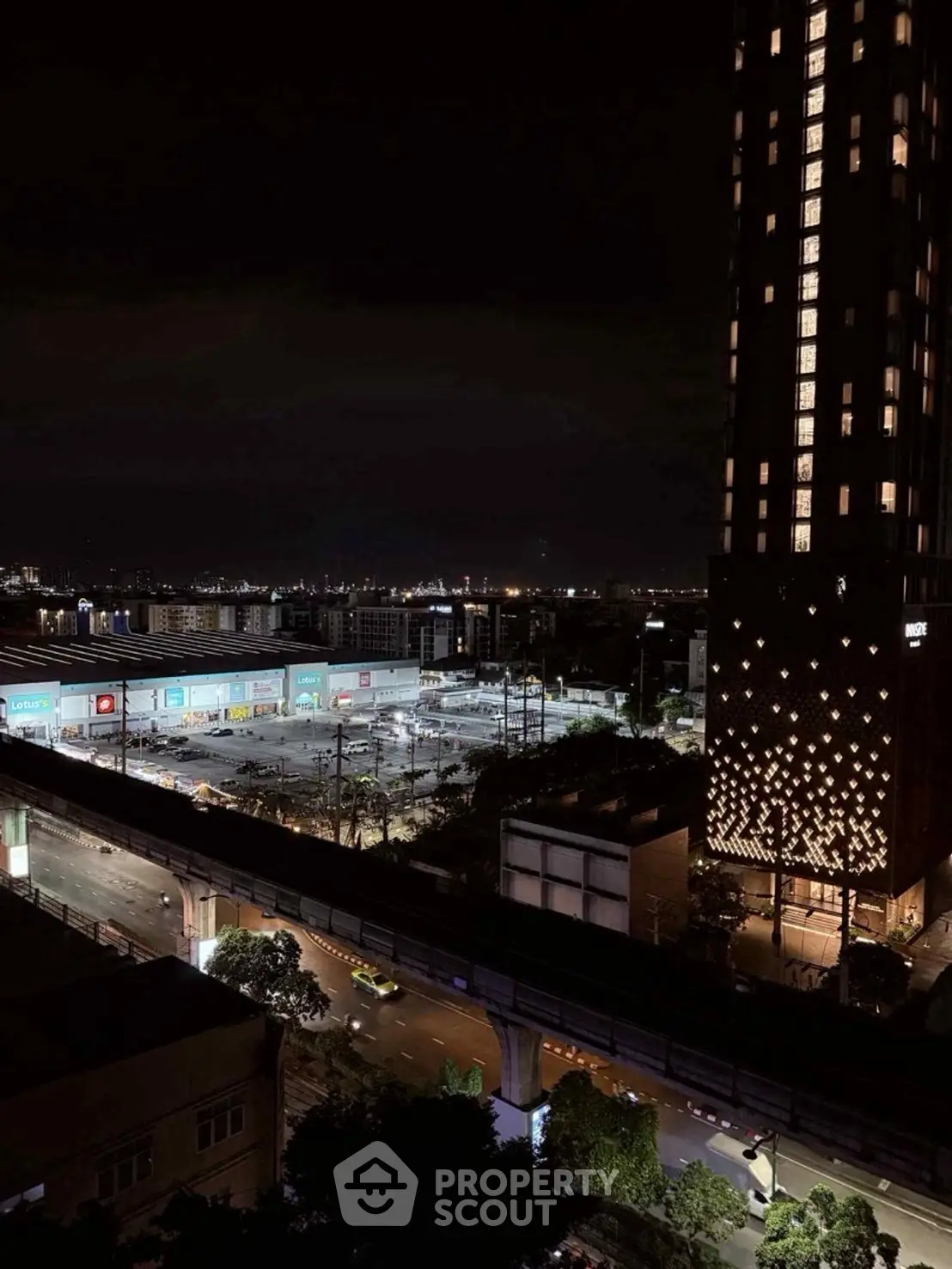 Stunning night view of cityscape with illuminated high-rise building and urban landscape.