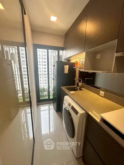 Modern kitchen with sleek cabinetry and integrated appliances in high-rise apartment.