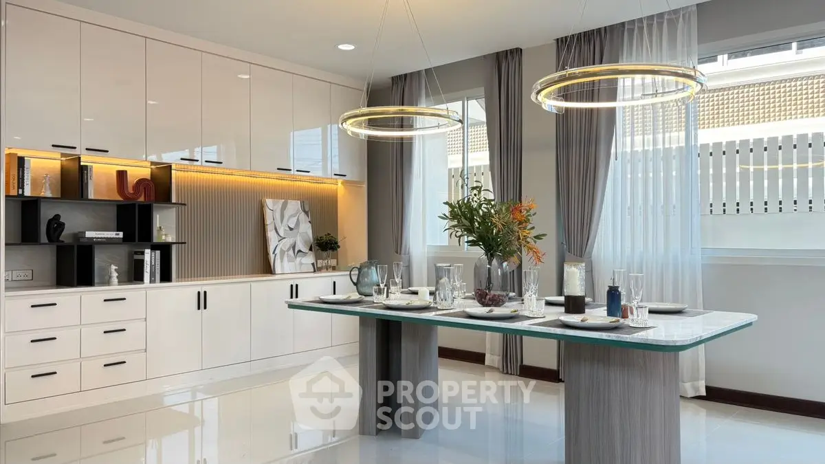 Elegant modern kitchen with sleek cabinetry and stylish dining area