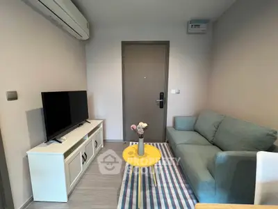 Cozy living room with modern decor, featuring a comfortable sofa, TV, and stylish coffee table.