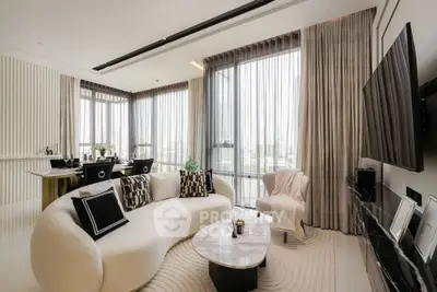 Luxurious modern living room with elegant decor and large windows offering stunning views.