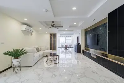 Spacious modern living room with elegant marble flooring and stylish furniture.