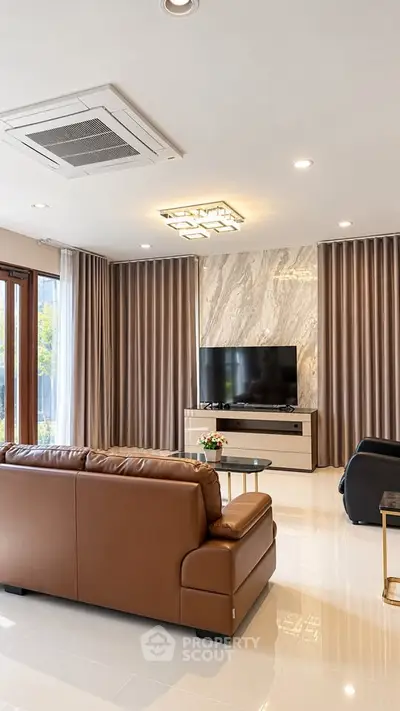 Luxurious living room with modern decor, leather sofa, and large TV, perfect for relaxation and entertainment.