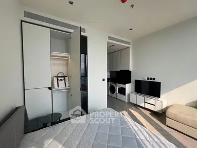 Modern apartment interior with sleek design, featuring a cozy living area, built-in storage, and natural light.
