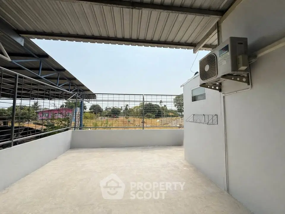 Spacious rooftop terrace with air conditioning unit and open view, perfect for relaxation and entertainment.