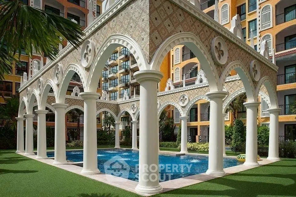 Luxurious architectural pool area with elegant arches and lush greenery.