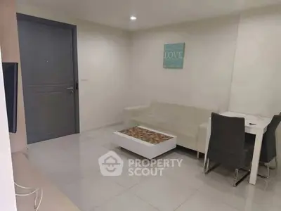 Modern living room with sleek furniture and minimalist decor in a cozy apartment.