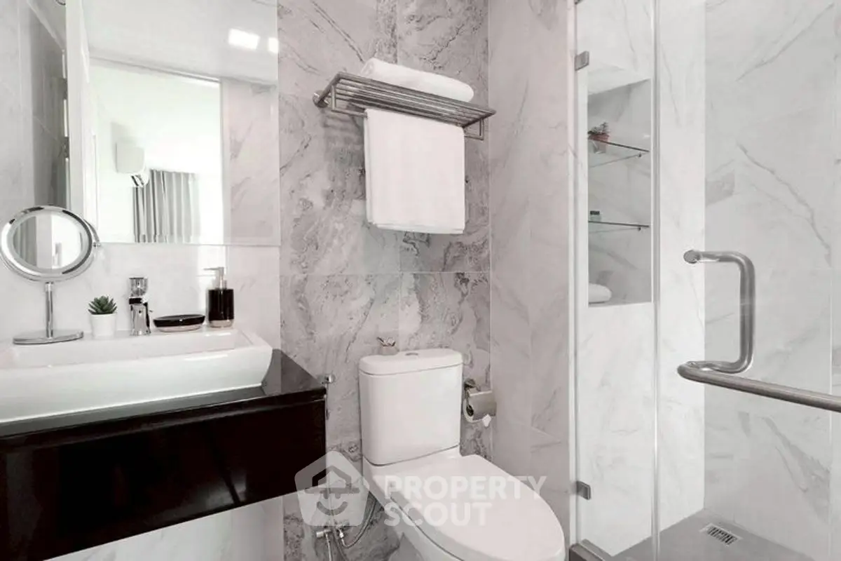 Modern bathroom with sleek fixtures and marble walls