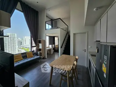 Modern loft apartment with high ceilings and city view, featuring open living area and stylish kitchen.