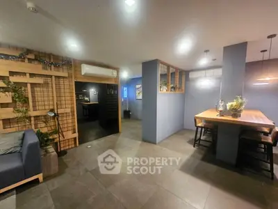 Modern open-plan living and dining area with stylish decor and ambient lighting.