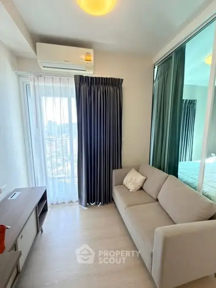 Modern living room with cozy sofa and city view through large window