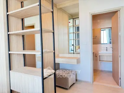 Modern bedroom with wooden shelving and ensuite bathroom