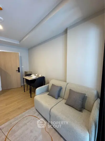 Modern living room with cozy sofa and dining area in stylish apartment