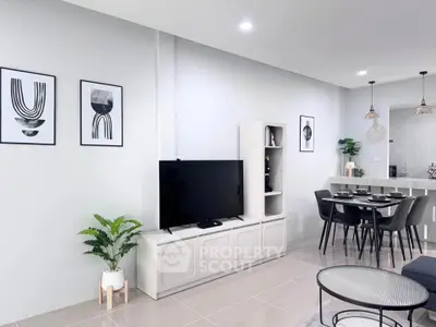 Modern living room with sleek decor and open dining area, perfect for contemporary living.