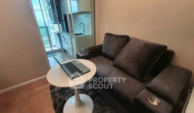 Cozy living room with plush sofa and balcony view, perfect for urban living.