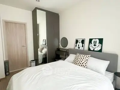 Modern bedroom with stylish decor and cozy bedding in a contemporary apartment.