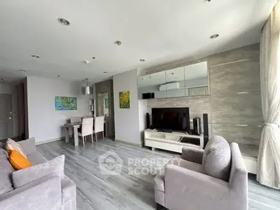 Spacious modern living room with stylish decor and large windows for natural light.