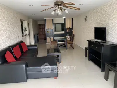 Spacious living room with modern furniture and open layout in a stylish apartment.