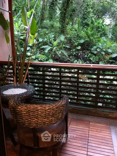 Charming balcony with lush green forest view, perfect for relaxation and nature lovers.