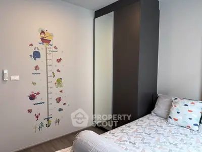 Charming children's bedroom with playful wall decor and cozy bedding