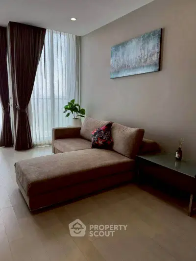 Modern living room with stylish sofa and floor-to-ceiling windows in a chic apartment.