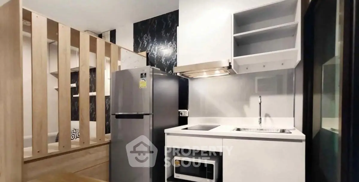 Modern compact kitchen with sleek appliances and stylish design