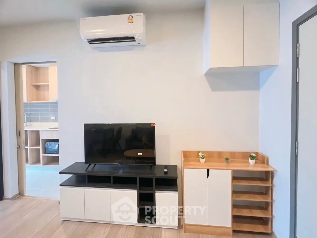 Modern living room with sleek furniture and wall-mounted air conditioner