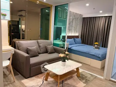 Modern studio apartment with cozy living area and stylish bedroom