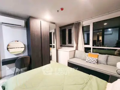 Modern bedroom with stylish decor and large windows for natural light.