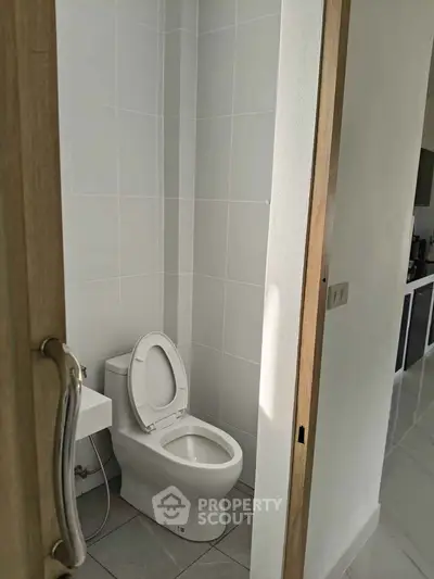 Modern bathroom with sleek toilet and minimalist design.