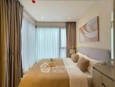 Luxurious bedroom with elegant decor and large windows offering natural light.
