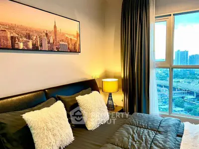 Modern bedroom with city view, featuring stylish decor and large window for natural light.