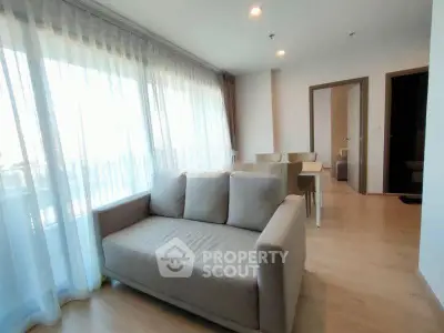 Bright and airy living room with modern decor and large windows in a stylish apartment.