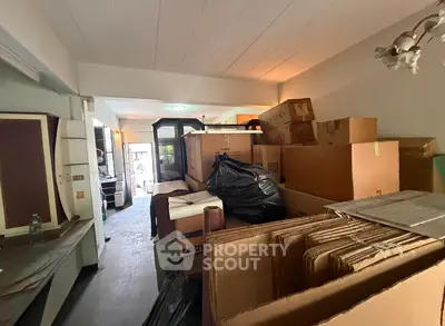 Spacious storage room filled with moving boxes and packing materials, ideal for organizing belongings.