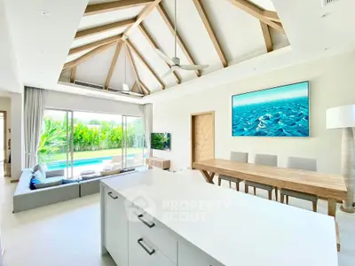 Luxurious open-plan living room with pool view and modern decor