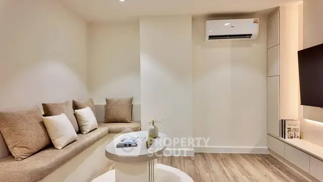 Modern living room with built-in seating and air conditioning, perfect for cozy relaxation.