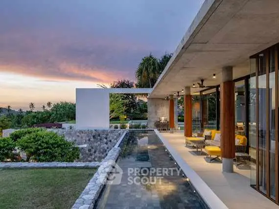 Stunning modern home with expansive outdoor area and scenic sunset view.