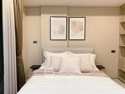 Elegant bedroom with stylish decor and cozy bedding in modern apartment.