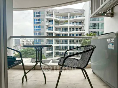 Modern balcony with seating and city view in contemporary apartment building.