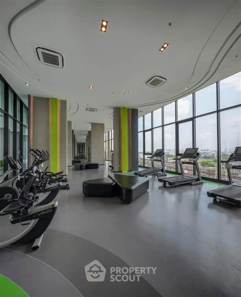 Modern gym with panoramic city views and state-of-the-art fitness equipment.