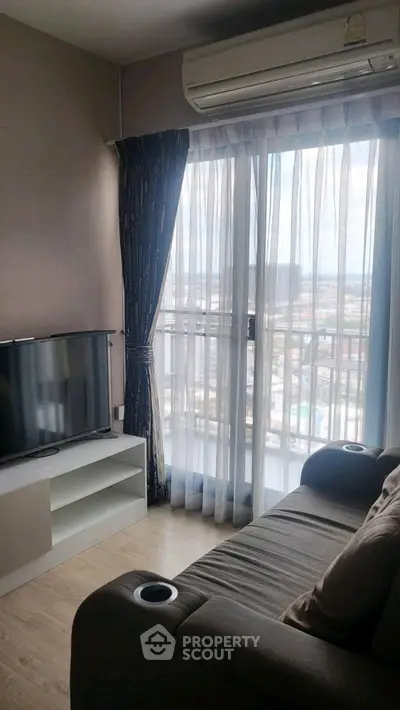 Cozy living room with city view, modern sofa, and entertainment center.