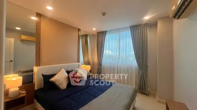 Luxurious bedroom with modern decor and large window offering natural light.