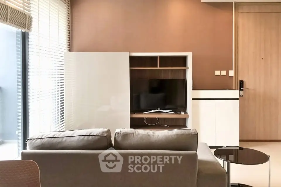 Modern living room with sleek furniture and natural light, perfect for relaxation and entertainment.