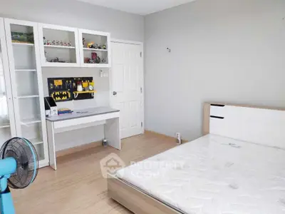 Modern bedroom with minimalist design, featuring a sleek bed, study desk, and ample storage space.