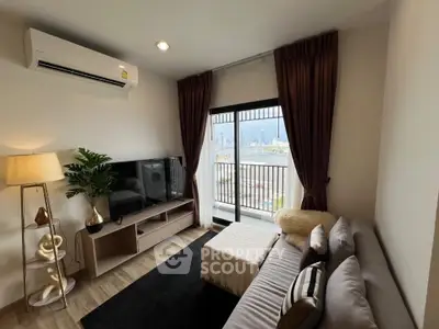 Modern living room with balcony view, stylish decor, and natural light.