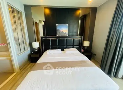 Luxurious bedroom with modern decor and elegant lighting in upscale apartment.